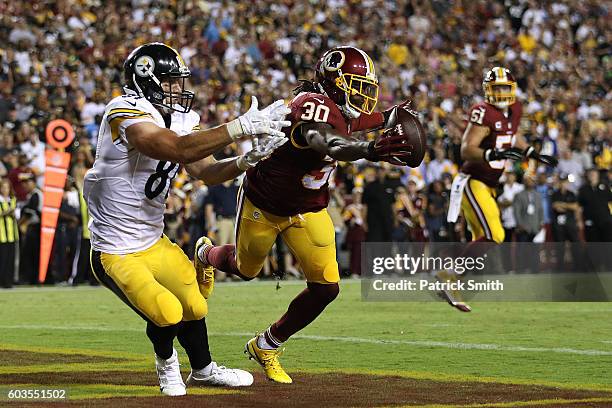 Defensive back David Bruton of the Washington Redskins breaks up a pass intended for tight end Jesse James of the Pittsburgh Steelers in the second...