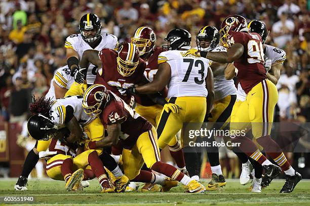 Running back DeAngelo Williams of the Pittsburgh Steelers is tackled by inside linebacker Mason Foster of the Washington Redskins in the second...