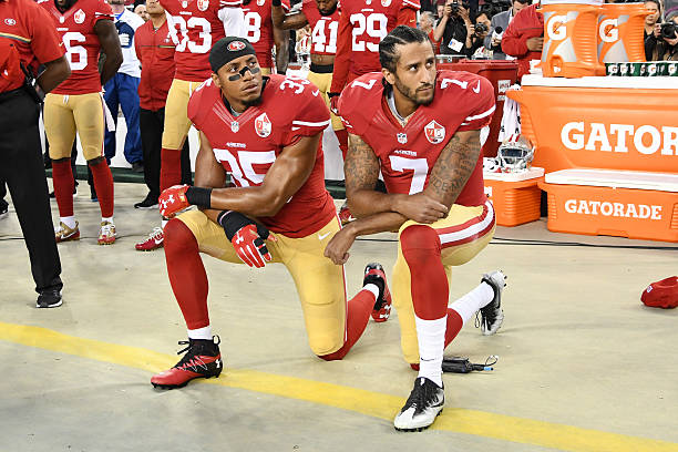 Colin Kaepernick and Eric Reid of the San Francisco 49ers kneel in protest during the national anthem prior to playing the Los Angeles Rams in their...