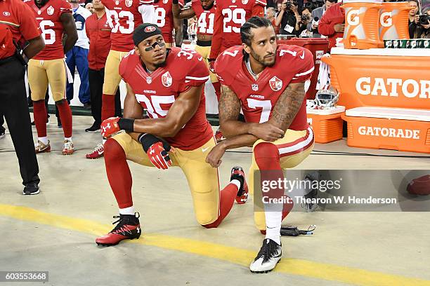 Colin Kaepernick and Eric Reid of the San Francisco 49ers kneel in protest during the national anthem prior to playing the Los Angeles Rams in their...