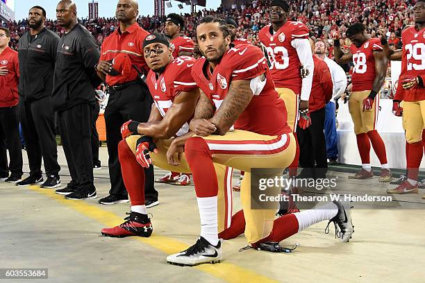 Colin Kaepernick and Eric Reid of the San Francisco 49ers kneel in protest during the national anthem prior to playing the Los Angeles Rams in their...