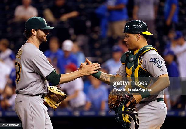 Felix Doubront and Bruce Maxwell of the Oakland Athletics congratulate each other after the A's defeated the Kansas City Royals with a final score of...