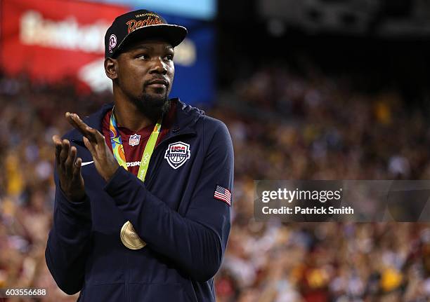 Gold medalist basketball player Kevin Durant of the United States acknowledges the crowd during a game between Pittsburgh Steelers and the Washington...