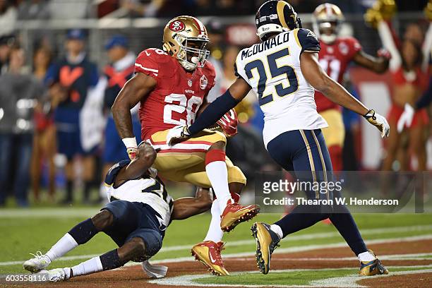 Carlos Hyde of the San Francisco 49ers scores a touchdown on a 11-yard run against the Los Angeles Rams during their NFL game at Levi's Stadium on...