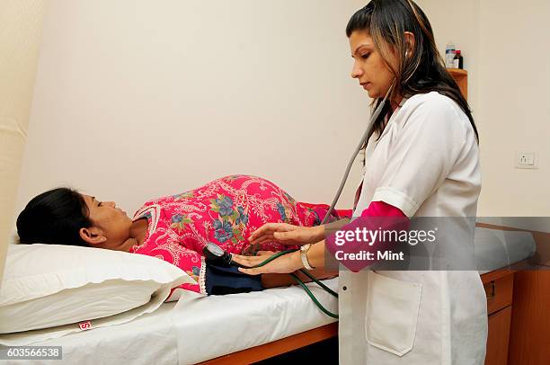 Surrogate mother, in last stage of her pregnancy, getting blood pressure examined, at the IVF Clinic on March 15, 2013 in New Delhi, India.