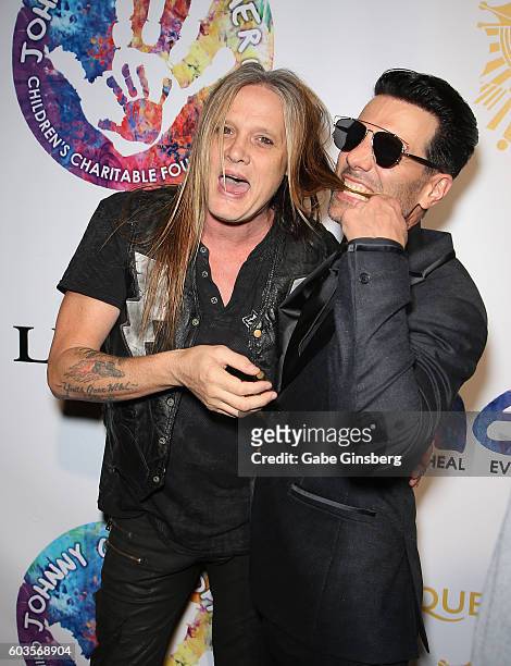 Singer Sebastian Bach jokes around with illusionist Criss Angel during Criss Angel's HELP charity event at the Luxor Hotel and Casino benefiting...