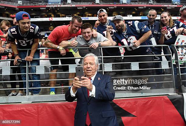New England Patriots owner Robert Kraft takes selfies with fans before his team's NFL game against the Arizona Cardinals at University of Phoenix...