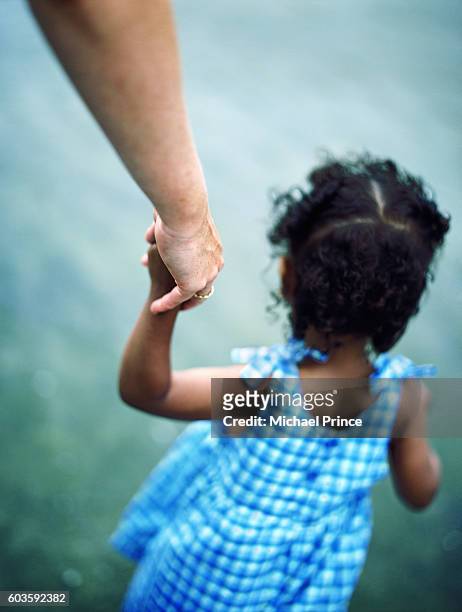 holding daughter's hand - vintage mother and child stock pictures, royalty-free photos & images