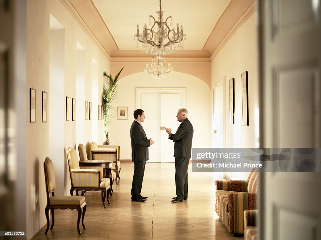 Businessmen Talking in Hallway