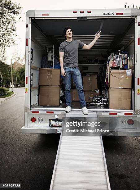 man standing in moving van - camión de las mudanzas fotografías e imágenes de stock