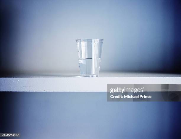 half glass of water - pessimisme stock pictures, royalty-free photos & images