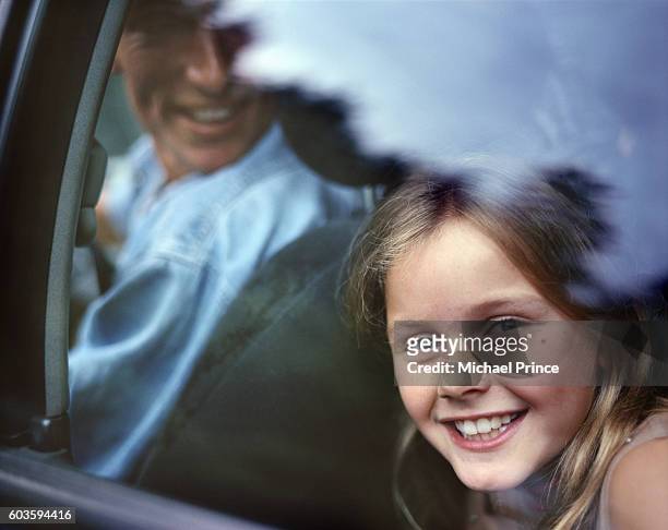 smiling girl in back seat of car - family on the move stock pictures, royalty-free photos & images