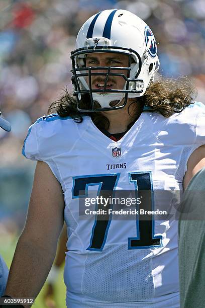 Dennis Kelly of the Tennessee Titans plays watches from the sideline during a game against the Minnesota Vikings at Nissan Stadium on September 11,...