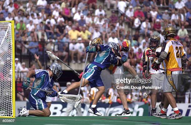 Rob Doerr of the Baltimore Bayhawks keeps John Grant of the Rochester Rattlers out of the play as Baltimore goalie Greg Cattrano covers the ball...