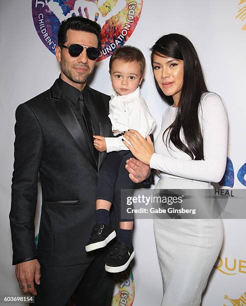 Illusionist Criss Angel, his son Johnny Crisstopher Sarantakos and Shaunyl Benson attend Criss Angel's HELP charity event at the Luxor Hotel and...