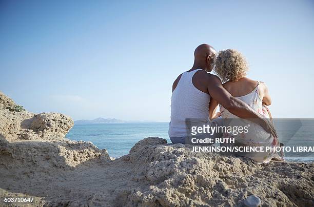 couple sitting on a rock - 2015 45 50 stock pictures, royalty-free photos & images