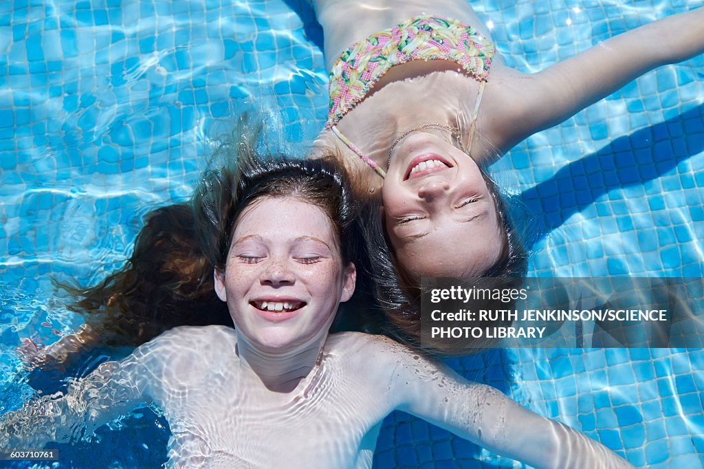 Tween Floating Inpool Two Girls Floating In Water High-Res Stock Photo - Getty Images