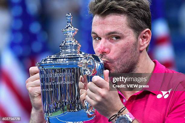 Stan Wawrinka of Switzerland celebrates with the trophy after his victory over Novak Djokovic of Serbia during their Men's Singles Final Match of the...