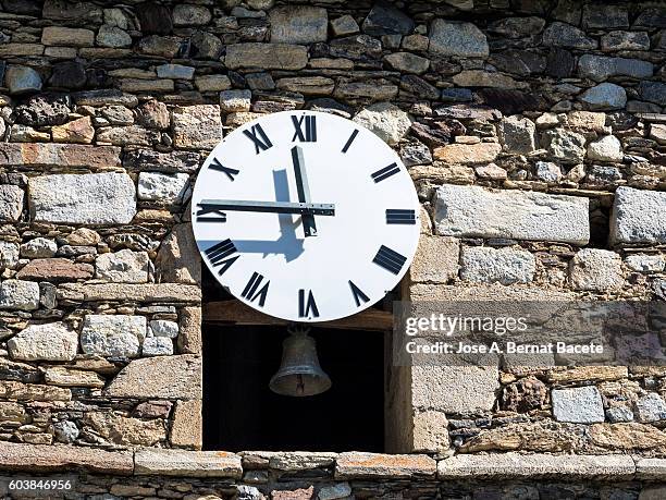 tower of an ancient belfry with a bell and a modern clock - broken hourglass stock pictures, royalty-free photos & images
