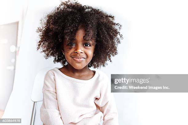 adorable girl looking at camera - afro stockfoto's en -beelden