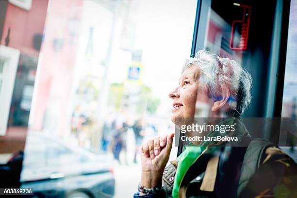 senior woman in the bus - people on buses stockfoto's en -beelden