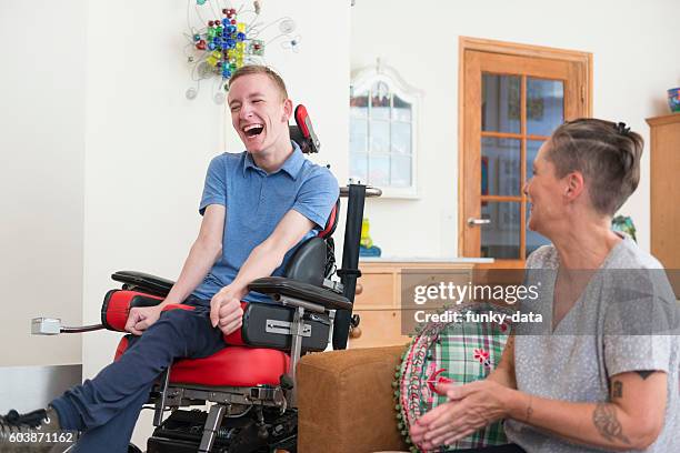 happy young als patient with his mom - cerebal palsy stockfoto's en -beelden