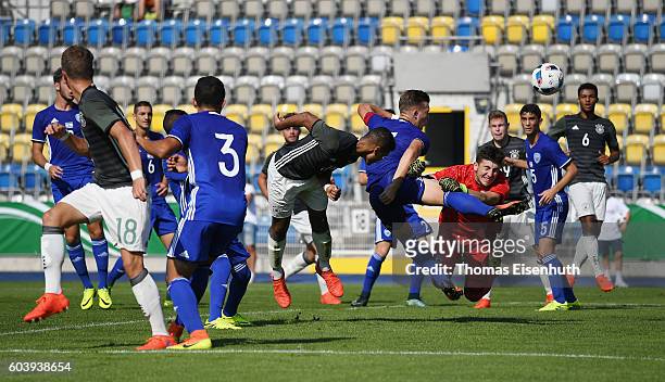 Noah Awuku of Germany with a header against goalie Roei Maoz and Eden Karzev of Israel during the Under 17 four nations tournament match between U17...