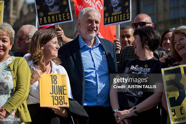 British Labour party Leader Jeremy Corbyn stands with campaigners outside the Houses of Parliament in central London on September 13 during a protest...