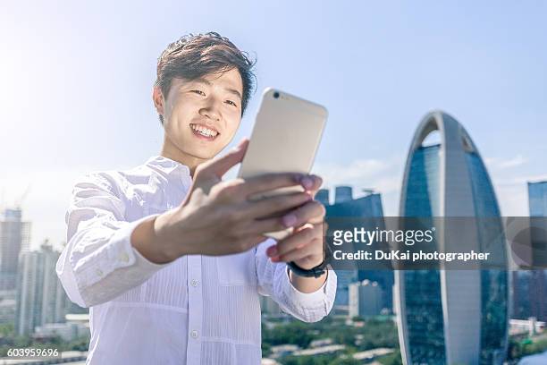 businessman using smartphone in beijing cbd - smart communicate elevation view stock-fotos und bilder
