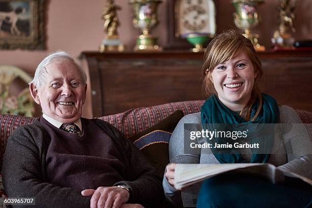 a retired antique dealer and his granddaughter - old man young woman fotografías e imágenes de stock