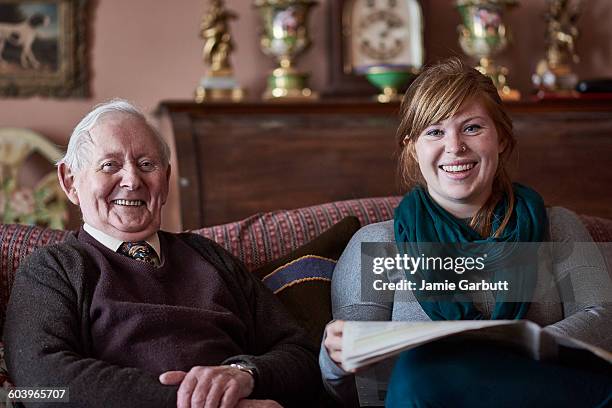 a retired antique dealer and his granddaughter - antique sofa styles foto e immagini stock