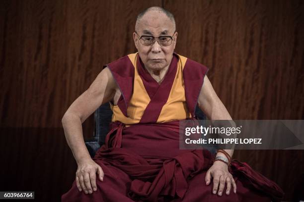 The Dalai Lama attends a press conference at a hotel in Paris on September 13, 2016 as he visits France for the first time in five years.