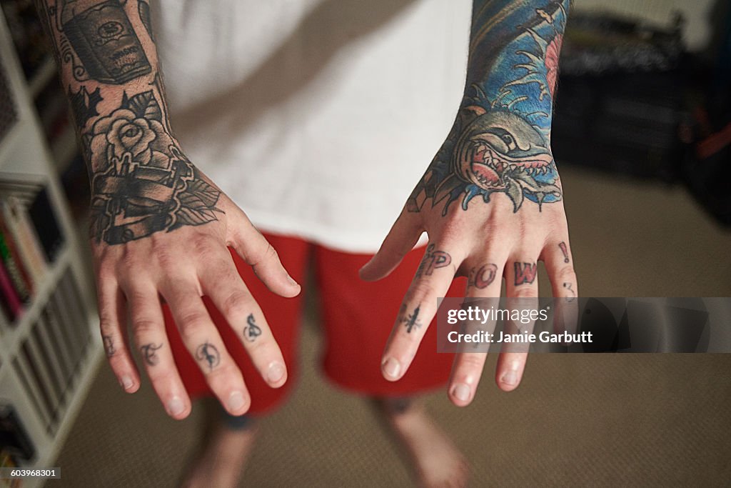 Close up of a mid 20's tattoo enthusiasts hands