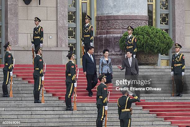 Chinese President Xi Jinping and his wife Peng Liyuan attend to the welcoming ceremony of Peru President outside the Great Hall of the People on...