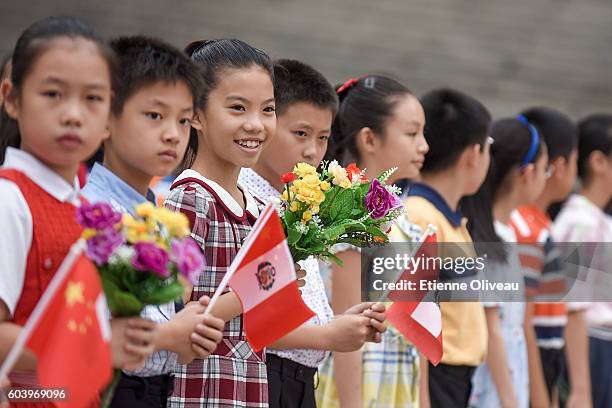 Kids await the beginning of the welcoming ceremony of Peruvian President outside the Great Hall of the People on September 13, 2016 in Beijing, China.