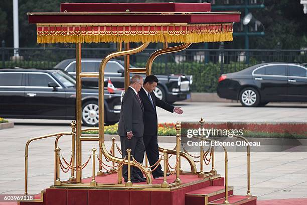 Chinese President Xi Jinping invites Peruvian President Pedro Pablo Kuczynski to review an honour guard during a welcoming ceremony outside the Great...