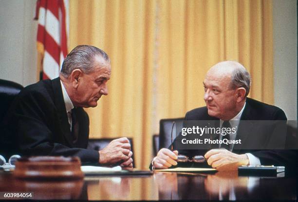 American politicians US President Lyndon B Johnson confers with Secretary of Defense Dean Rusk at a conference table in the White House, Washington...