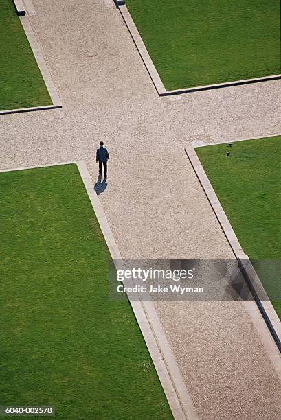 man at crossroads - crossroad stock pictures, royalty-free photos & images