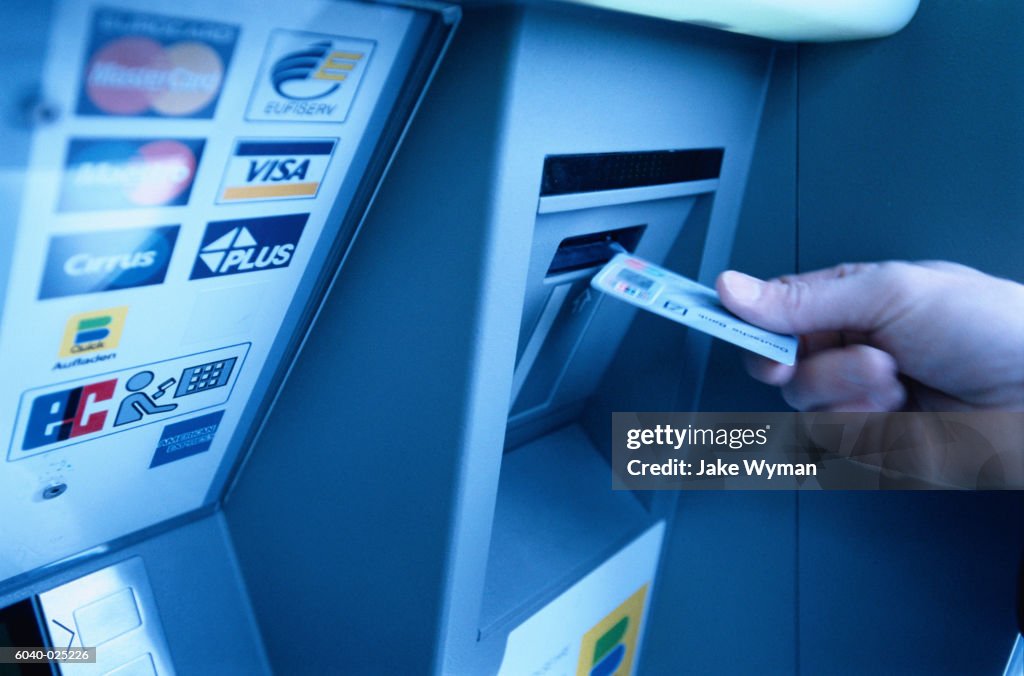 Hand Putting Card into ATM