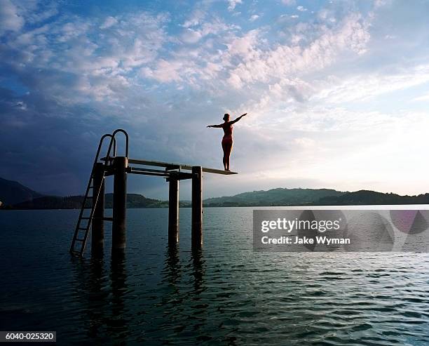 woman on diving board in lake - person diving stock pictures, royalty-free photos & images