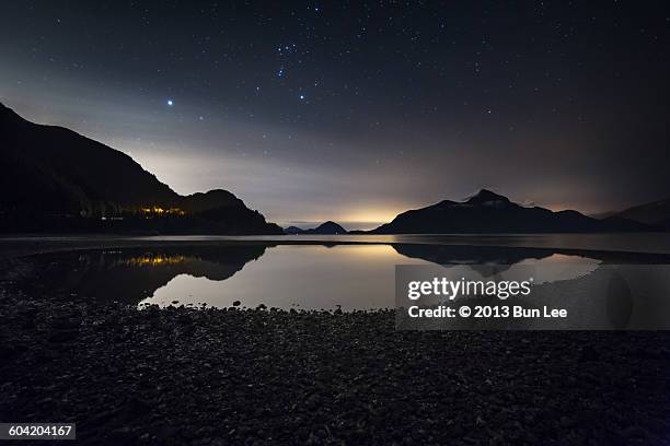 low tide night with orion's belt above - orion belt stock pictures, royalty-free photos & images