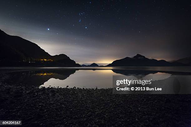 low tide night with orion's belt above - orion lee stock pictures, royalty-free photos & images
