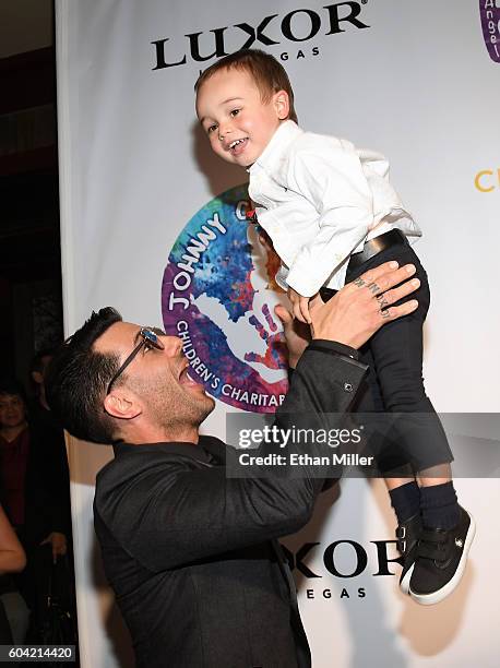 Illusionist Criss Angel tosses his son Johnny Crisstopher Sarantakos in the air at Criss Angel's HELP charity event at the Luxor Hotel and Casino...