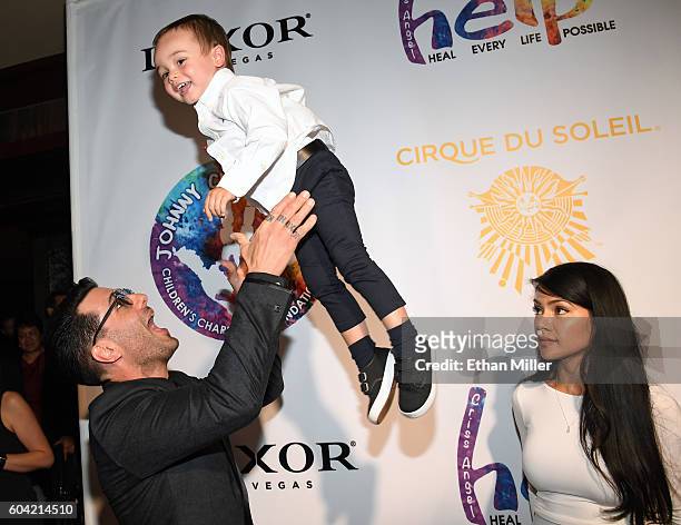 Illusionist Criss Angel tosses his son Johnny Crisstopher Sarantakos in the air as his mother Shaunyl Benson looks on at Criss Angel's HELP charity...