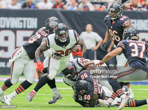 Lamar Miller of the Houston Texans rushes past Jerrell Freeman of the Chicago Bears and Bryce Callahan during a NFL football game at NRG Stadium on...
