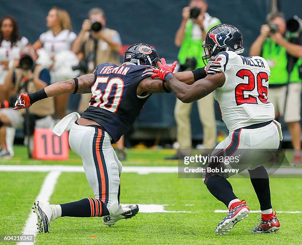 Lamar Miller of the Houston Texans rushes past Jerrell Freeman of the Chicago Bears during a NFL football game at NRG Stadium on September 11, 2016...