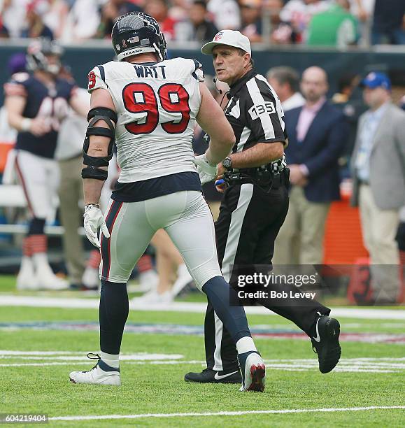 Watt of the Houston Texans talks with referee referee Pete Morelli during a NFL football game at NRG Stadium on September 11, 2016 in Houston, Texas.