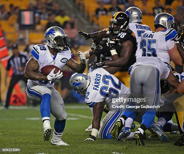 Running back Stevan Ridley of the Detroit Lions runs with the football as offensive lineman Chase Farris blocks linebacker Vince Williams of the...