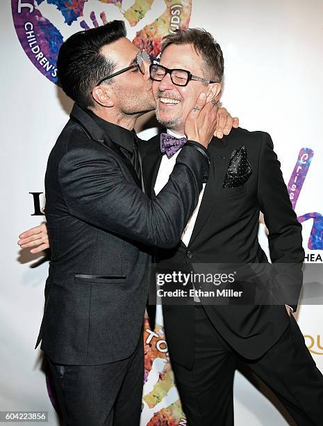 Illusionist Criss Angel kisses actor Gary Oldman at Criss Angel's HELP charity event at the Luxor Hotel and Casino benefiting pediatric cancer...