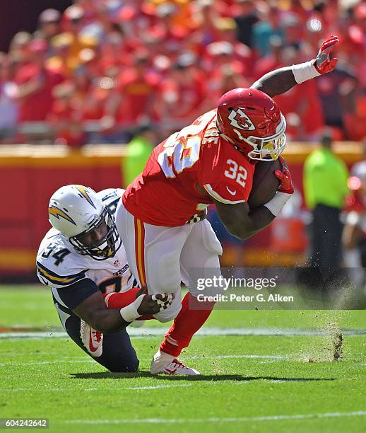 Defensive tackle Corey Liuget of the San Diego Chargers tackles running back Spencer Ware of the Kansas City Chiefs during the first half on...